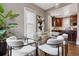 Bright dining room with modern table, stylish chairs, and views into adjacent kitchen at 321 S Emerson St, Denver, CO 80209