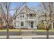 Charming two-story home with a welcoming front porch and beautifully landscaped front yard at 321 S Emerson St, Denver, CO 80209