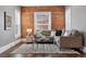 Cozy living room featuring a brick wall, comfortable seating, and abundant natural light at 321 S Emerson St, Denver, CO 80209