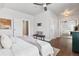 Bright main bedroom featuring hardwood floors, a ceiling fan, and a bench seat at 321 S Emerson St, Denver, CO 80209