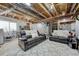 Spacious basement lounge area with plush seating and exposed ceiling at 23413 E Dorado Pl # A, Aurora, CO 80016