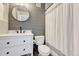 Modern bathroom with grey paneling, white vanity and walk-in shower at 23413 E Dorado Pl # A, Aurora, CO 80016