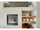Close-up view of a modern fireplace, built-in shelves, and stylish decor at 23413 E Dorado Pl # A, Aurora, CO 80016