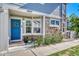Charming townhome entrance features a blue door, stone accents, and well-maintained landscaping at 23413 E Dorado Pl # A, Aurora, CO 80016
