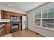 Functional kitchen with stainless steel appliances, wooden cabinets, and ample counter space at 23413 E Dorado Pl # A, Aurora, CO 80016