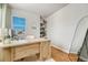 Bright office features hardwood floors, custom shelves, and a well-lit workspace with a modern desk at 23413 E Dorado Pl # A, Aurora, CO 80016