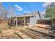 Spacious backyard featuring garden boxes, a wooden deck, and covered patio at 3921 S Acoma St, Englewood, CO 80110