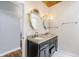 Bathroom featuring granite countertops, dual sinks, modern faucets and vanity lighting at 3921 S Acoma St, Englewood, CO 80110