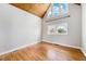 Bright bedroom featuring hardwood floors, natural light, and a vaulted wood ceiling at 3921 S Acoma St, Englewood, CO 80110