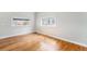 Bright, spacious bedroom with pristine hardwood floors and natural light from two large windows at 3921 S Acoma St, Englewood, CO 80110