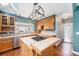 Well-equipped kitchen featuring custom cabinets, tile countertops and a stainless steel dishwasher at 3921 S Acoma St, Englewood, CO 80110
