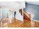Open-concept living space showcasing hardwood floors, staircase, and natural light from French doors at 3921 S Acoma St, Englewood, CO 80110