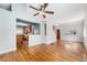 Sun-drenched living room featuring beautiful hardwood floors, neutral walls, and stylish ceiling fan at 3921 S Acoma St, Englewood, CO 80110