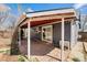 Covered patio featuring brick pavers, white columns and gray vinyl siding at 3921 S Acoma St, Englewood, CO 80110