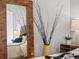 Bedroom with natural lighting, modern decor, and a decorative mirror at 891 14Th St # 3204, Denver, CO 80202