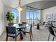 Stylish dining area with modern seating, a glass table, and large windows offering a city view at 891 14Th St # 3204, Denver, CO 80202
