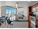 Bright modern kitchen with an island, sleek countertops, and city views from large windows at 891 14Th St # 3204, Denver, CO 80202