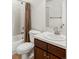 A classic bathroom with a shower-tub combination, vanity and tiled backsplash at 8739 E 23Rd Ave, Denver, CO 80238