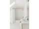 Bright, all-white bathroom with classic fixtures and a shower-tub combination and hexagon tile floor at 8739 E 23Rd Ave, Denver, CO 80238