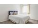 Sunlit bedroom features a plush bed with an upholstered headboard and view to the exterior at 8739 E 23Rd Ave, Denver, CO 80238