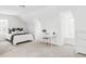 Bright all-white bedroom features a sloped ceiling, white bed and matching office nook at 8739 E 23Rd Ave, Denver, CO 80238