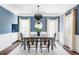 Dining room with blue accent wall, chandelier, and modern table setting at 8739 E 23Rd Ave, Denver, CO 80238