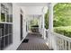 Charming front porch featuring classic columns, wood flooring and porch swing overlooking mature landscaping at 8739 E 23Rd Ave, Denver, CO 80238