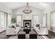 Bright living room with vaulted ceilings, fireplace, and elegant chandelier at 8739 E 23Rd Ave, Denver, CO 80238