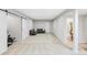 An open, light-filled bonus room with dual seating areas and an ensuite bathroom at 8739 E 23Rd Ave, Denver, CO 80238