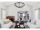 Open-concept living space with view to the kitchen and piano at 8739 E 23Rd Ave, Denver, CO 80238
