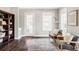 Cozy living room with two armchairs, hardwood floors, light grey walls, and a decorative rug at 8739 E 23Rd Ave, Denver, CO 80238