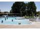 Resort-style community pool with fountains, ample seating, and shade offers a perfect summer gathering spot at 8739 E 23Rd Ave, Denver, CO 80238