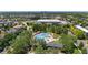 Aerial view of a beautiful community pool area with lounge chairs, tables, and umbrellas for residents to enjoy in a landscaped surrounding at 8739 E 23Rd Ave, Denver, CO 80238