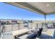 Enjoy mountain views from this covered deck with modern outdoor seating at 8795 Hugo Dr, Littleton, CO 80125