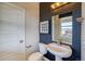 Stylish half bathroom featuring modern fixtures and custom paint at 8795 Hugo Dr, Littleton, CO 80125