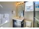 Clean bathroom with a modern vanity, well-lit mirror, and pristine fixtures at 8795 Hugo Dr, Littleton, CO 80125
