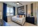 A well-lit bedroom with soft, neutral tones, and unique, stylish decorative touches throughout the room at 8795 Hugo Dr, Littleton, CO 80125
