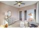 Bright bedroom featuring a rocking horse, floral wallpaper, chair and lots of natural light at 8795 Hugo Dr, Littleton, CO 80125