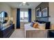 A well-lit bedroom with soft, neutral tones, and unique, stylish decorative touches throughout the room at 8795 Hugo Dr, Littleton, CO 80125