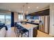 Modern kitchen with quartz island, stainless steel appliances, and backyard view at 8795 Hugo Dr, Littleton, CO 80125