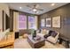 Comfortable living room with sleek furniture, ceiling fan and natural light in a new home at 8795 Hugo Dr, Littleton, CO 80125