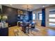 Stylish living room with dark accent wall, contemporary decor, and hardwood floors at 8795 Hugo Dr, Littleton, CO 80125