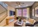 Comfortable living room with sleek furniture, ceiling fan and natural light in a new home at 8795 Hugo Dr, Littleton, CO 80125