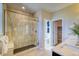 Modern shower with a glass door, seat, and dark tile floor inside a new home at 8795 Hugo Dr, Littleton, CO 80125