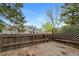 A wooden back deck with a privacy fence, and a view of a neighboring building, great for outdoor relaxation at 17151 E Stanford Ave # B, Aurora, CO 80015