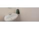 The bathroom features a pedestal sink, a round mirror, and a towel rack with a green towel at 17151 E Stanford Ave # B, Aurora, CO 80015