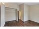 Bedroom features hardwood floors, a large closet with shelving, and white trim at 17151 E Stanford Ave # B, Aurora, CO 80015