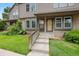 Inviting townhome entrance with landscaped garden, flowers, and a shared front porch at 17151 E Stanford Ave # B, Aurora, CO 80015