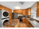 Well-equipped kitchen featuring stainless steel appliances, island, and in-unit laundry setup at 17151 E Stanford Ave # B, Aurora, CO 80015
