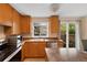 Well-lit kitchen features stainless steel appliances, a window over the sink, and a sliding glass door to the backyard at 17151 E Stanford Ave # B, Aurora, CO 80015